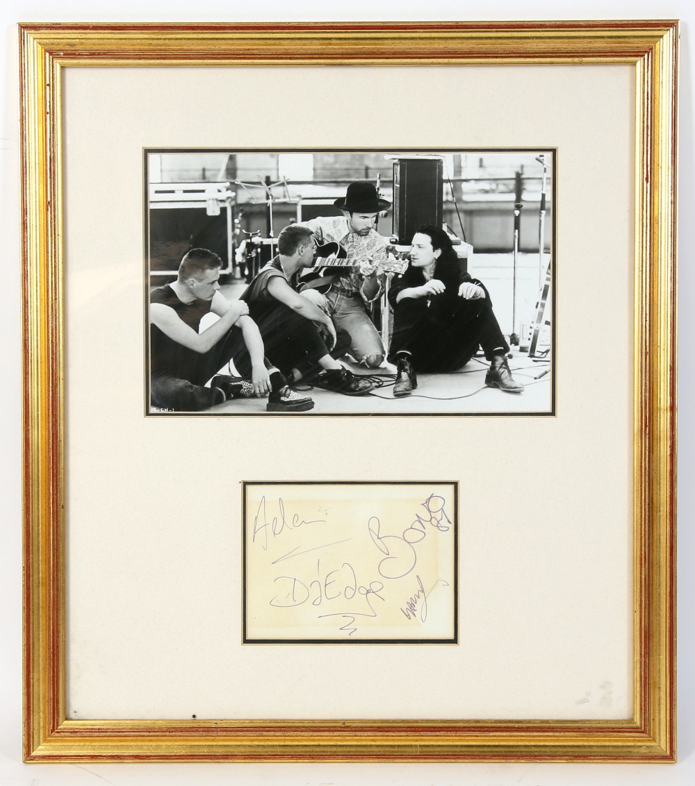 U2 - An early 1980’s set of autographs, mounted, framed & glazed with a black & white photo of the