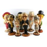 Eight Esco chalkware character figures including Stan Laurel, Oliver Hardy, John Wayne and the