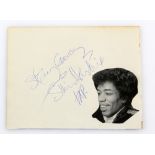 Jimi Hendrix “Stay Groovy” autograph, on part of a book cover page next to a cut-out image of