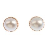 A pair of mid 20th century gold mabe pearl cufflinks. Each designed as a mabe pearl, with