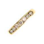 An 18ct gold diamond half eternity ring. The brilliant-cut diamond line, within a channel setting,