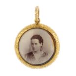 An early 20th century gold and enamel locket. Of circular outline, the glazed front, with blue and