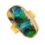 An opal dress ring. Designed as a boulder opal collet, with grooved band. Estimated dimensions of