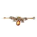 A gem-set insect bar brooch. Designed as a winged insect, with circular emerald cabochon eyes, old-
