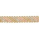 A 9ct gold necklace. Of tri-colour design, comprising seven rows of polished and textured brick