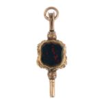 A mid Victorian watch key. Designed as a floral embossed key, with bloodstone and foil-backed gem