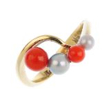 A coral and cultured pearl crossover ring. Designed as an alternating and graduated coral bead and