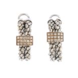 A pair of diamond hoop earrings. Each designed as a pave-set diamond panel, atop a series of fancy
