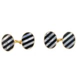 A pair of 9ct gold gem-set cufflinks. Each designed as two oval panels, with alternating onyx and