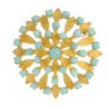A turquoise brooch. Designed as a circular turquoise cabochon openwork cluster, with textured leaf