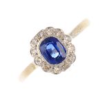 A sapphire and diamond cluster ring. The oval-shape sapphire, with single-cut diamond scalloped