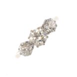 An 18ct gold diamond three-stone ring. The graduated old-cut and brilliant-cut diamond line, with