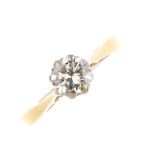 An 18ct gold diamond single-stone ring. The brilliant-cut diamond, with slightly tapered shoulders