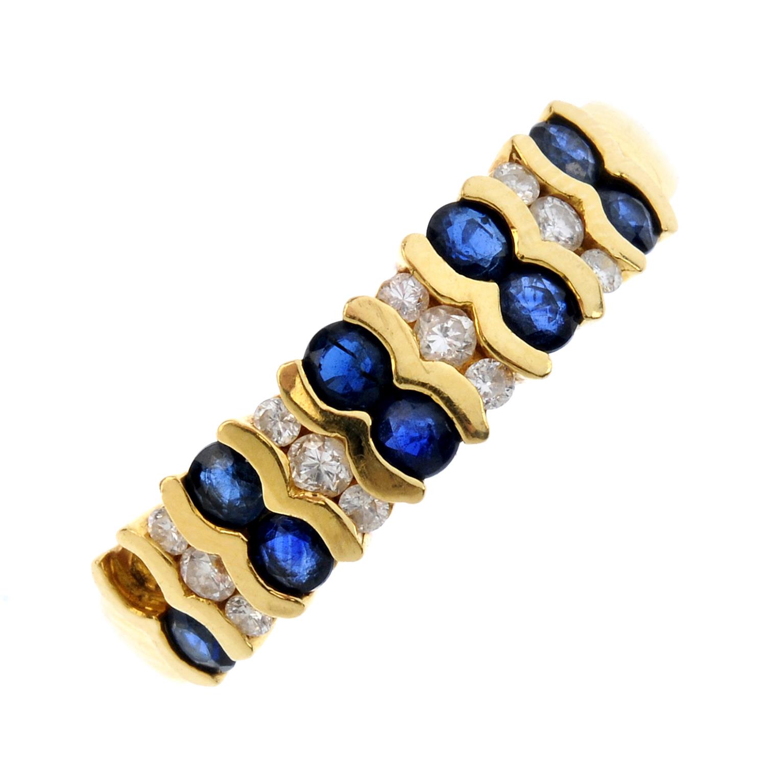 An 18ct gold sapphire and diamond ring. Designed as a series of alternating circular-shape