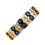 An 18ct gold sapphire and diamond ring. Designed as a series of alternating circular-shape