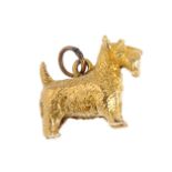 A 9ct gold dog charm. Designed as a textured Scottish Terrier, with hoop surmount. Hallmarks for