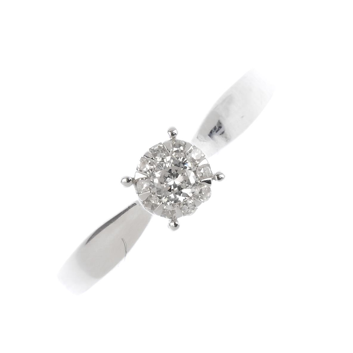 A 9ct gold diamond cluster ring. The brilliant-cut diamond, with single-cut diamond surround.