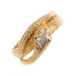 A gentleman's 9ct gold diamond snake ring. Designed as a textured coiled snake. with single-cut