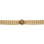 A sapphire bracelet. The circular-shape sapphire accent floral cluster, atop the textured fancy-link