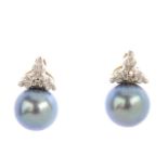 A pair of cultured pearl and diamond earrings. Each designed as a cultured pearl measuring 6.7mms