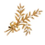 A 9ct gold seed pearl brooch. Designed as a spray of fern leaves tied in a ribbon, with seed pearl