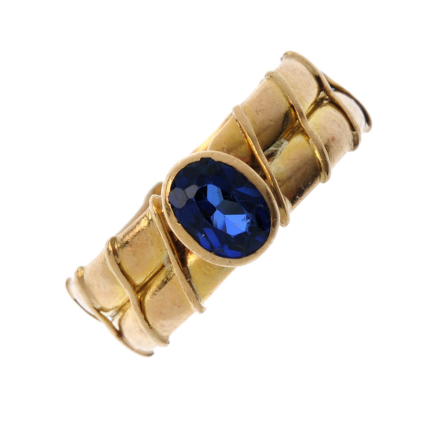 A sapphire single-stone ring. The oval-shape sapphire collet, atop the double band, with diagonal