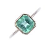 An emerald single-stone ring. The rectangular-shape emerald, with slightly tapered shoulders.