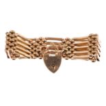 An early 20th century gold bracelet. Designed as a series of five-bar links, with textured brick-