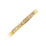 An 18ct gold diamond half eternity ring. The brilliant-cut diamond line, inset to the tapered