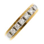 A 1970's 18ct gold diamond seven-stone ring. The brilliant-cut diamond line, atop a plain band.