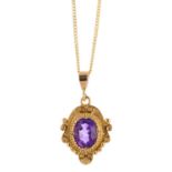 An amethyst pendant. The oval-shape amethyst, within a scrolling surround, suspended from a 9ct gold