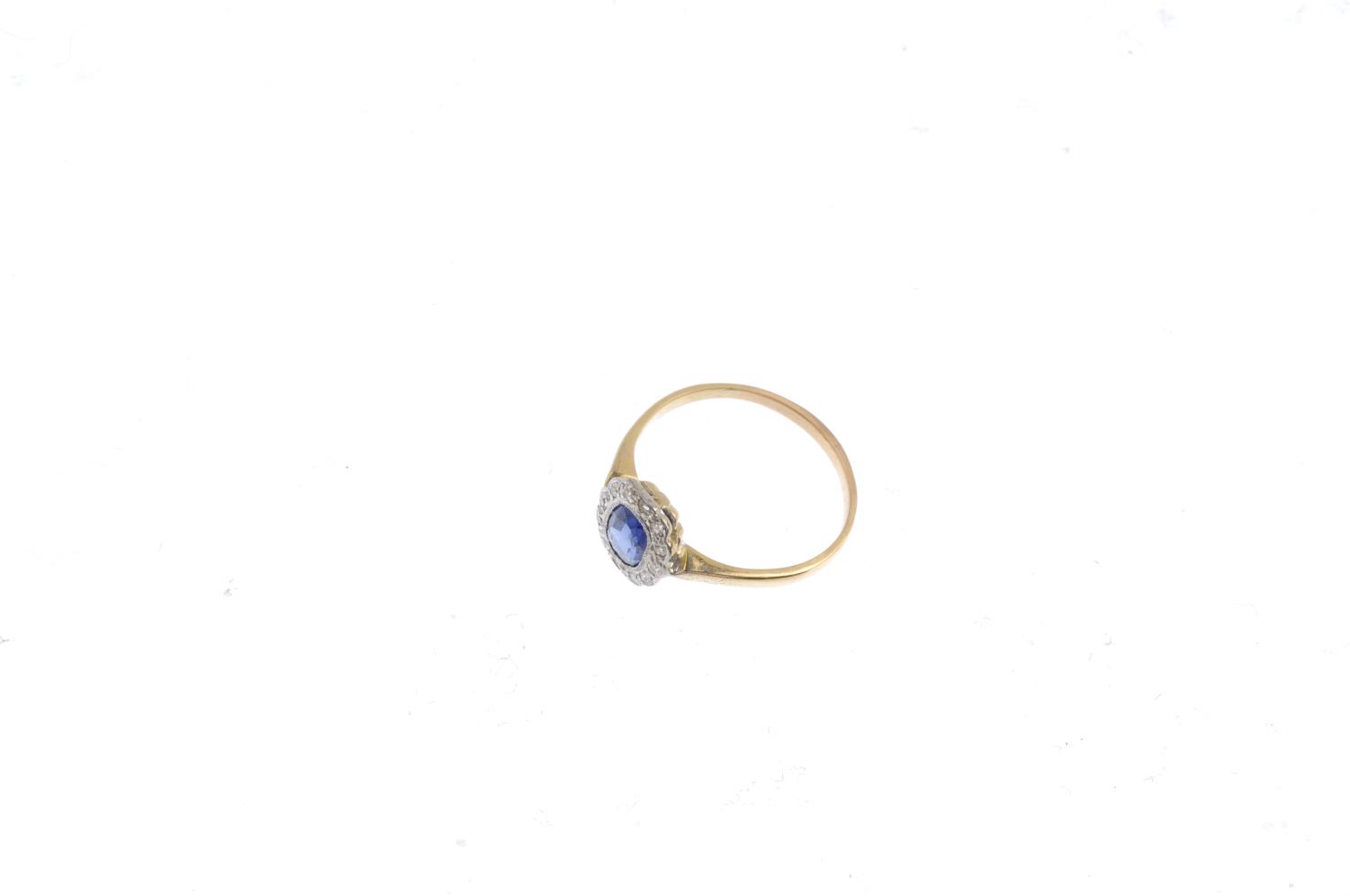 A sapphire and diamond cluster ring. The oval-shape sapphire, with single-cut diamond scalloped - Image 3 of 3