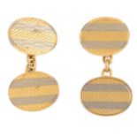 A pair of mid 20th century 18ct gold cufflinks. Each designed as two oval bi-colour panels, with