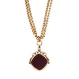 An Edwardian 9ct gold hardstone swivel fob, with longuard chain. The cushion-shape carnelian and