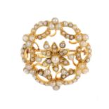 An early 20th century split pearl brooch. Of floral design, the split pearl cluster, with