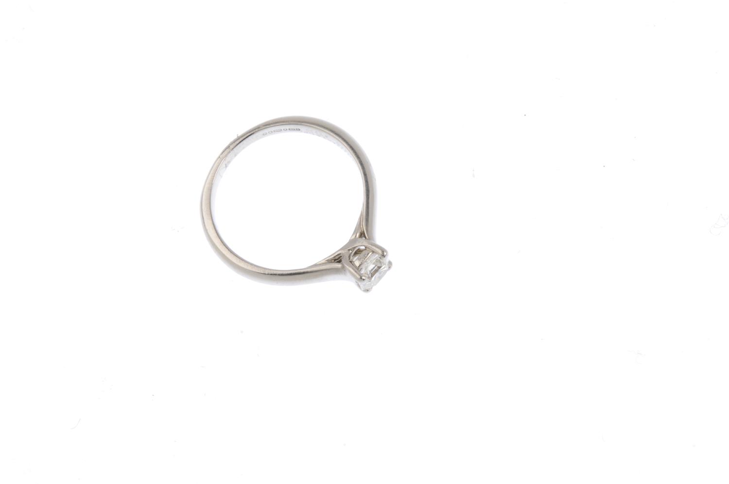 A platinum diamond single-stone ring. The square-cut diamond, with tapered shoulders. Diamond weight - Image 2 of 3