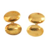 A pair of 1960s 18ct gold cufflinks. Each designed as two oval domed panels, with chain