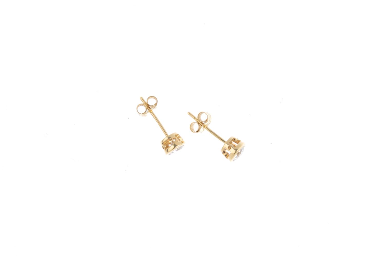 A pair of 18ct gold brilliant-cut diamond collet mounted stud-earrings. Total diamond weight 0.62ct, - Image 2 of 2