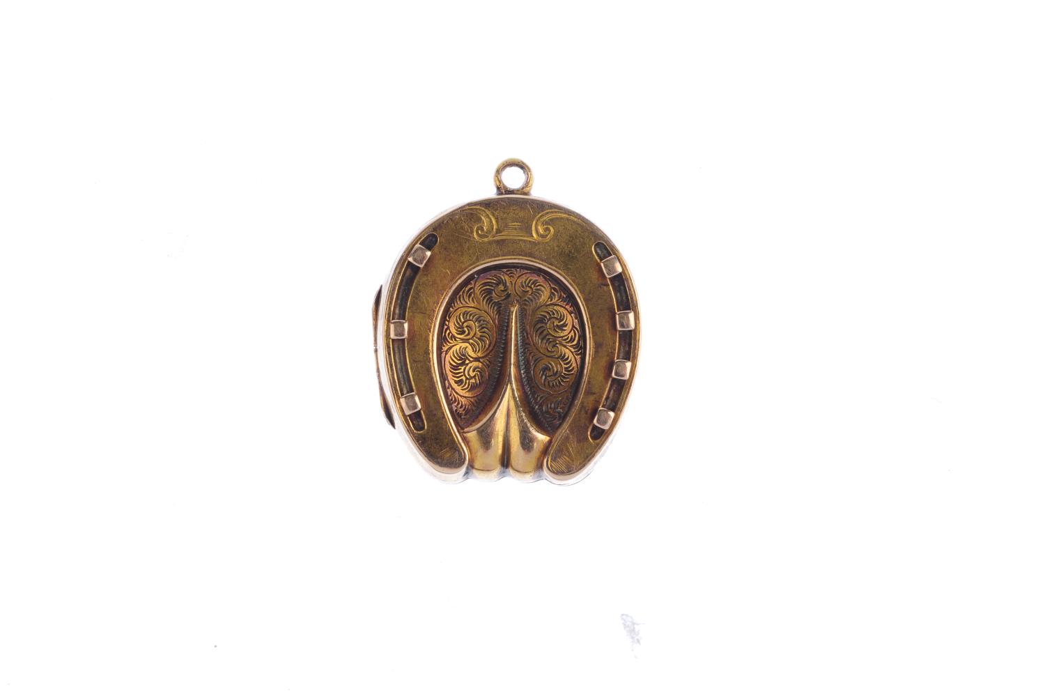 An early 20th century locket. The horseshoe locket, with engraved foliate motif and grooved - Image 2 of 3