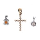 Three gem-set pendants. To include a 9ct gold colourless gem-set cross pendant, an 'orange'