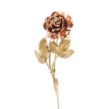 A 9ct gold diamond rose brooch. Of bi-colour design, the old-cut diamond accent rose, with