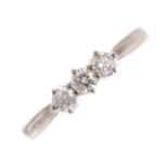 An 18ct gold diamond three-stone ring. The brilliant-cut diamond line, with grooved shoulders and