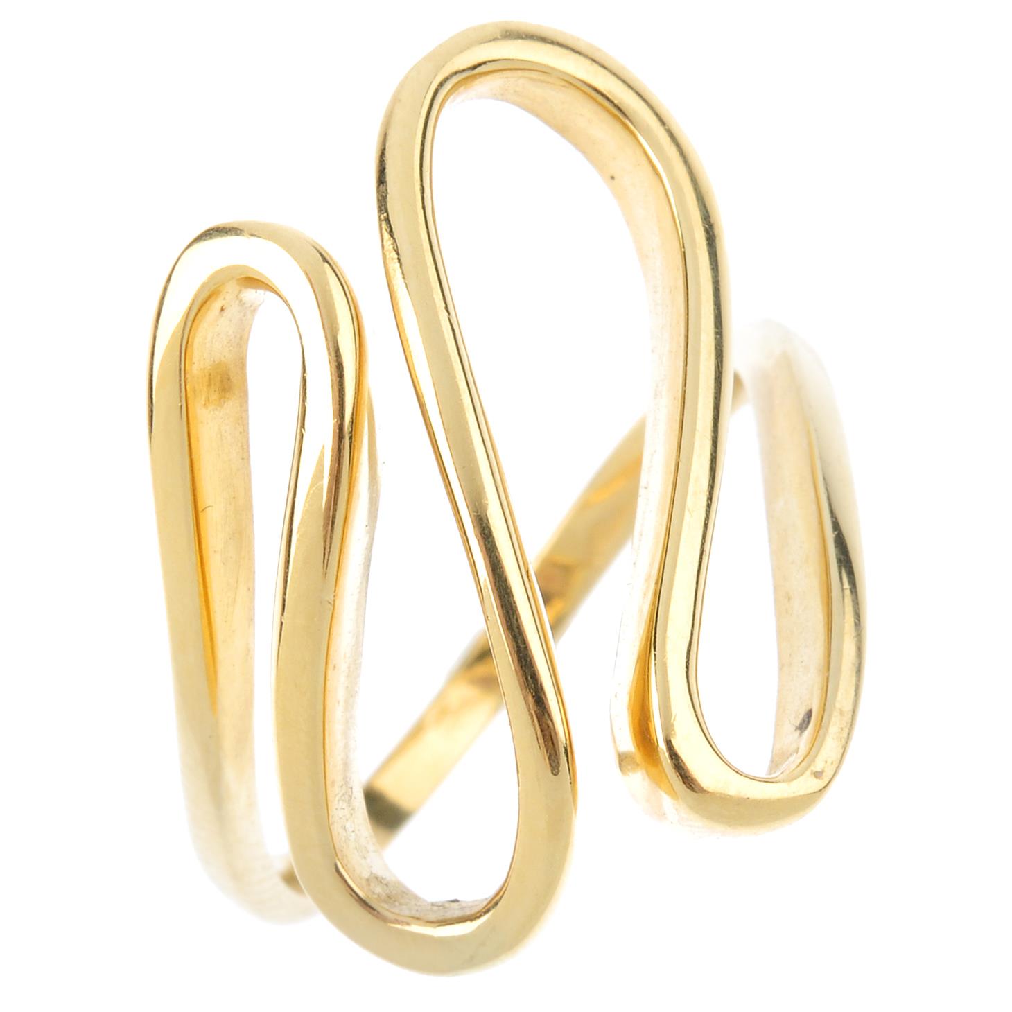 A dress ring. The front designed as a series of scrolling loops, with plain band. Ring size O.