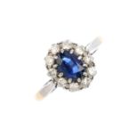 A sapphire and diamond cluster ring. The oval-shape sapphire, with brilliant-cut diamond surround.