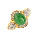 A jade and diamond dress ring. The oval jadeite cabochon, with brilliant-cut diamond curved surround