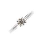 A diamond single-stone ring. The brilliant-cut diamond, with tapered shoulders and plain band.