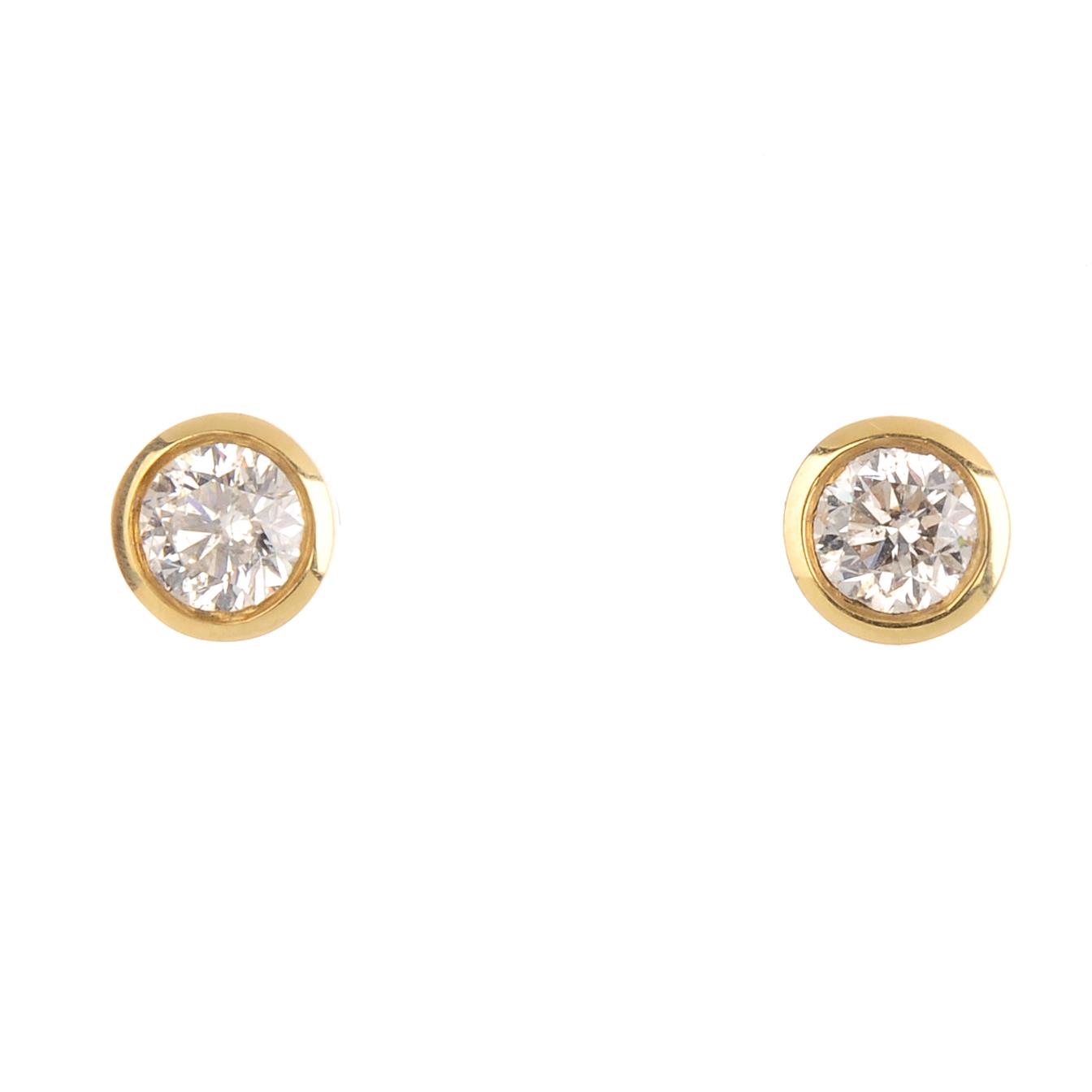 A pair of 18ct gold brilliant-cut diamond collet mounted stud-earrings. Total diamond weight 0.62ct,