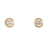 A pair of 18ct gold brilliant-cut diamond collet mounted stud-earrings. Total diamond weight 0.62ct,