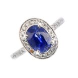 A sapphire and diamond cluster ring. The oval-shape sapphire, with brilliant-cut diamond surround