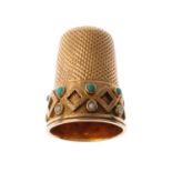 An early 20th century 15ct gold split pearl and turquoise thimble. The border with applied diamond-